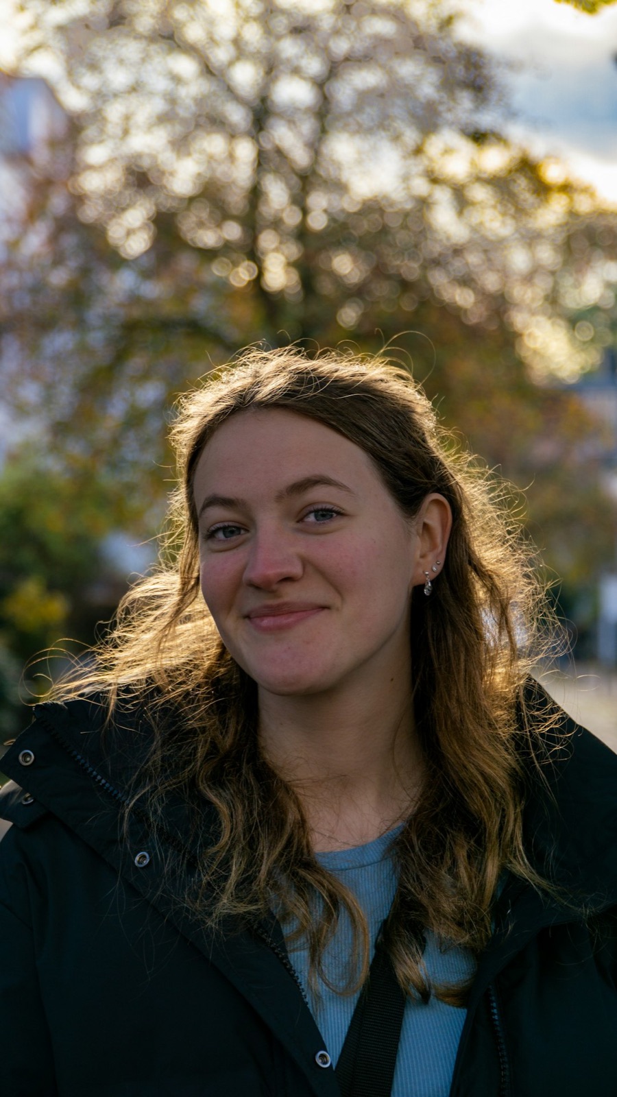 Anna Whitlow, smiling, outdoors in soft evening light
